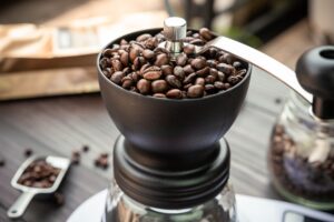 Coffee beans in a coffee grinder.