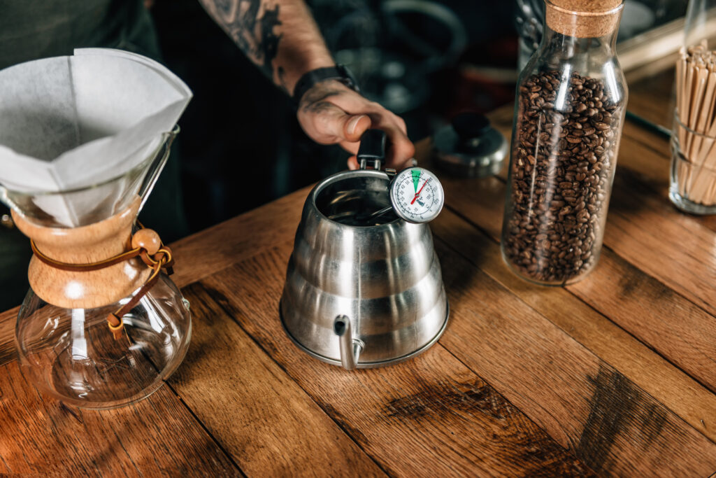 A kettle with a thermometer sticking out.