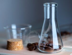 Coffee beans in laboratory glassware.